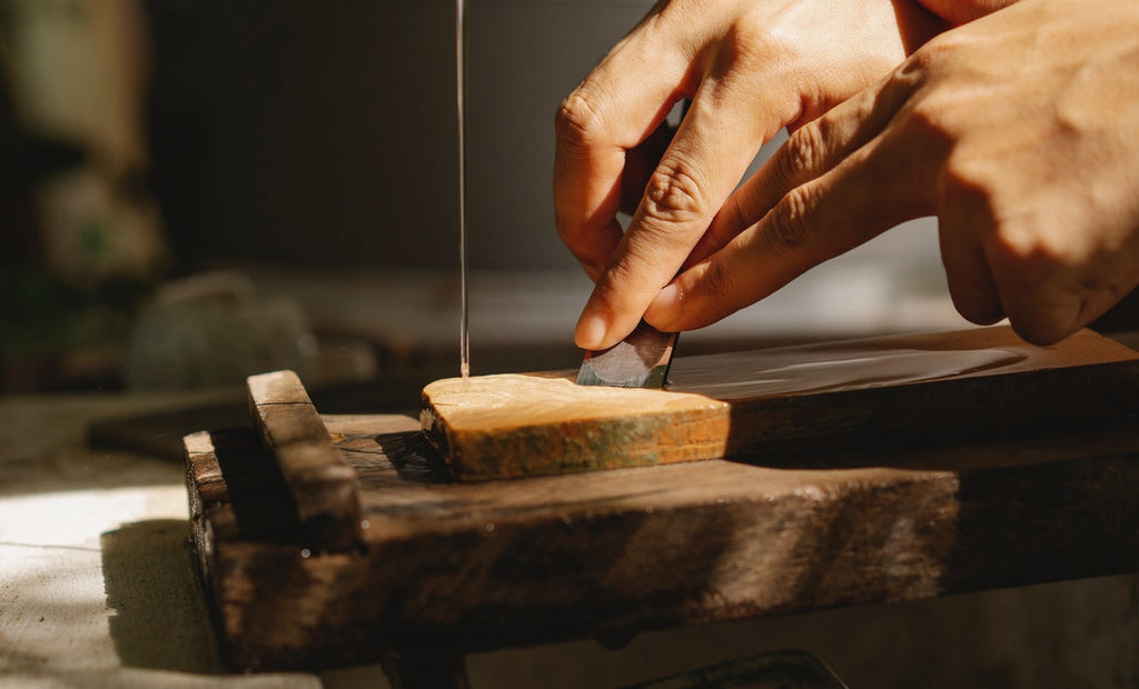 man sharpening knife on a whetstone